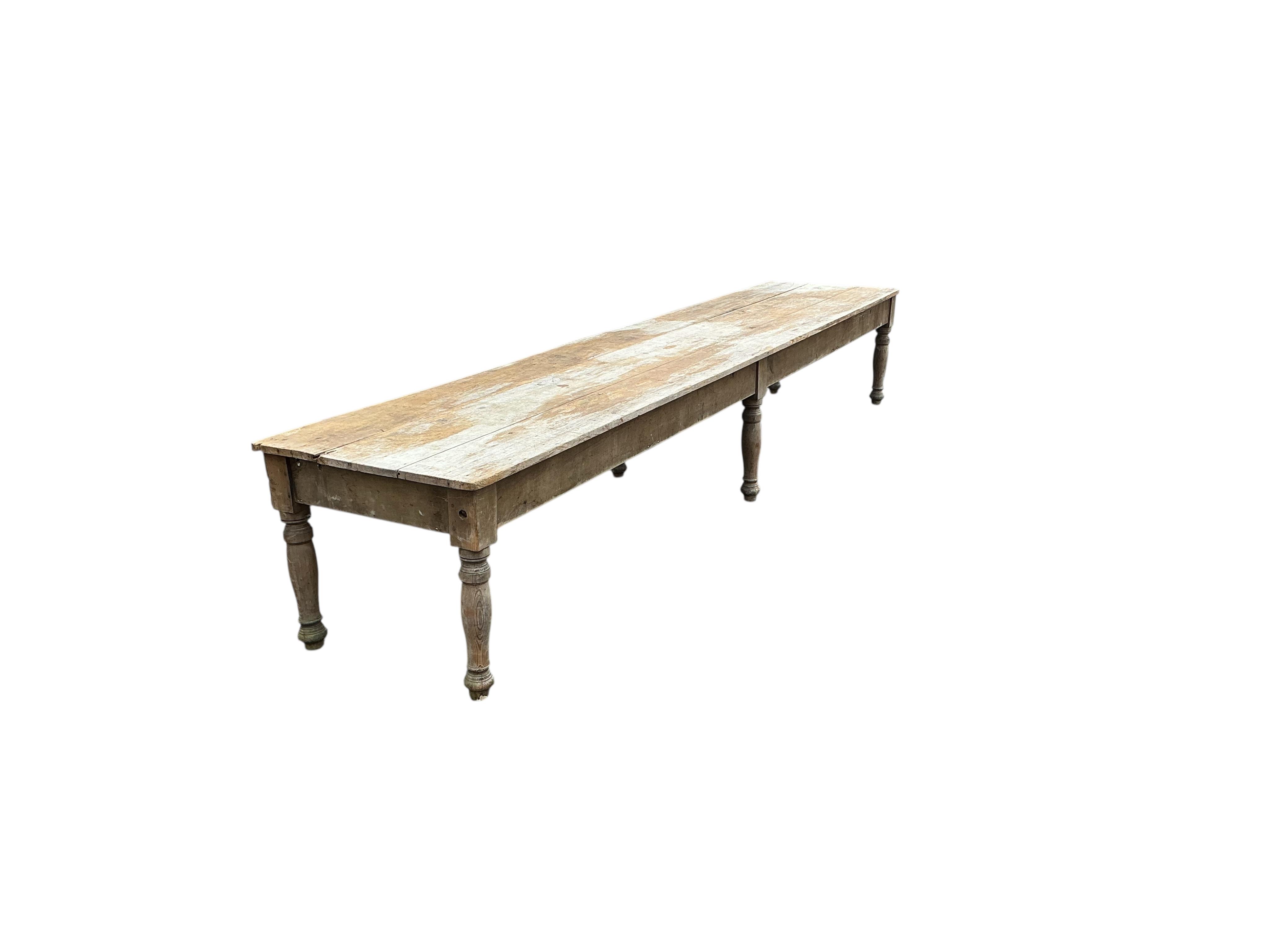 A long Victorian pine laundry table, length 600cm, width 104cm, height 86cm